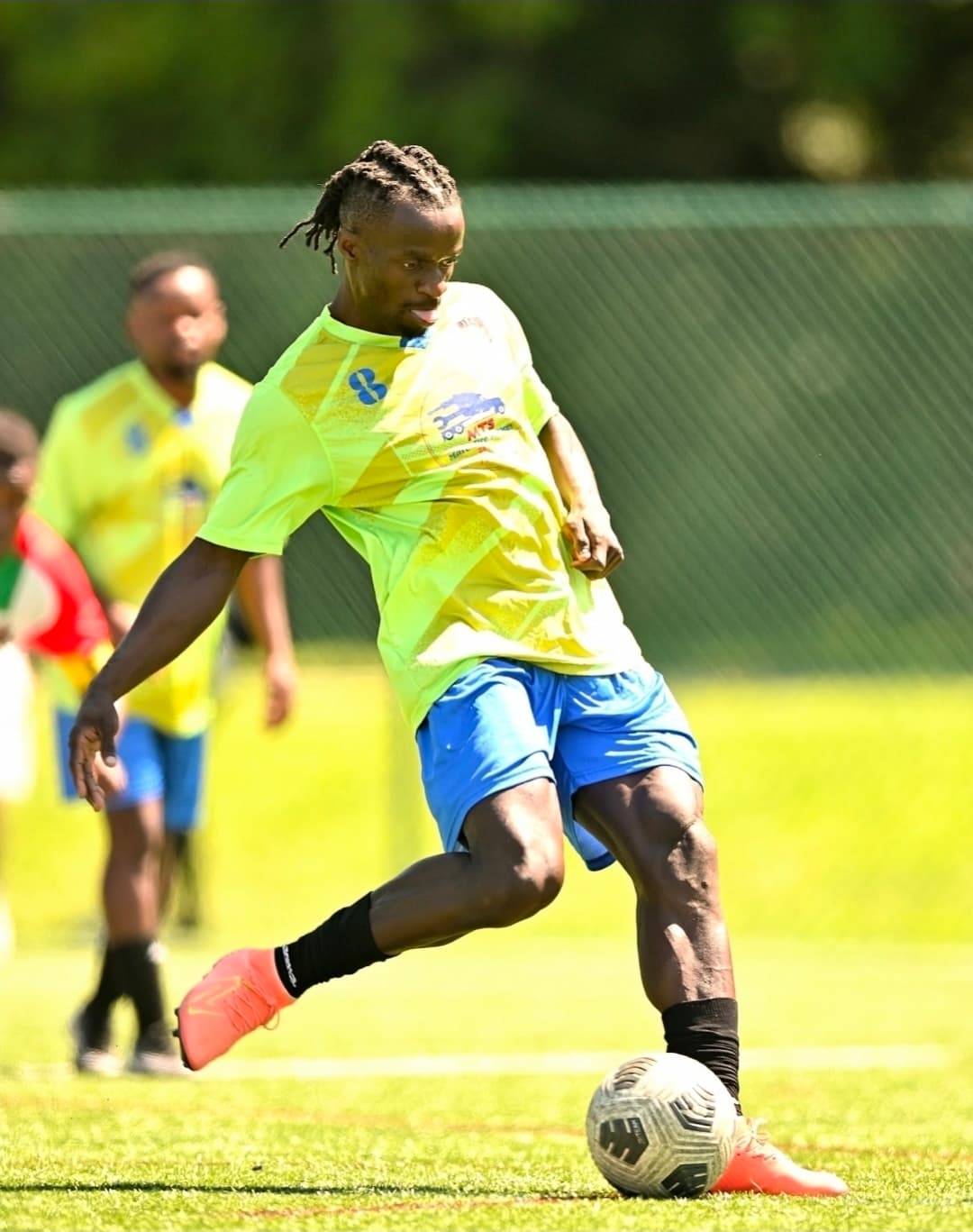 A JFC player in green and blue about to shoot