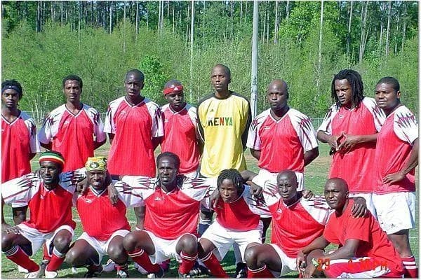 An early JFC squad in red shirts, kneeling and standing for a team photo